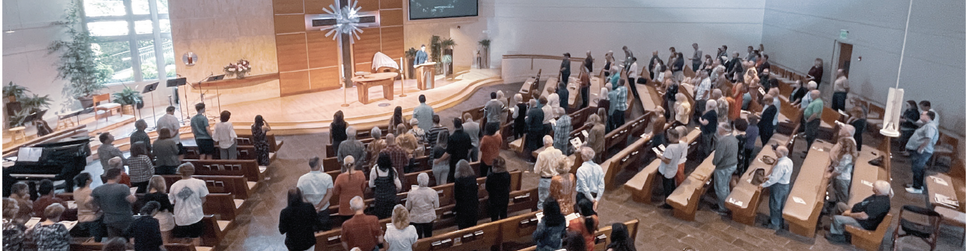 interior of sanctuary looking down from balcony during worship service on a Sunday morning