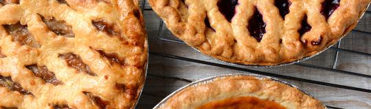 three pies on a wooden table